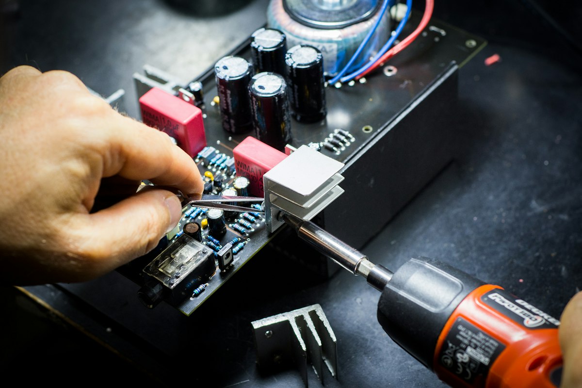 Working on a circuit board in an electronics workshop